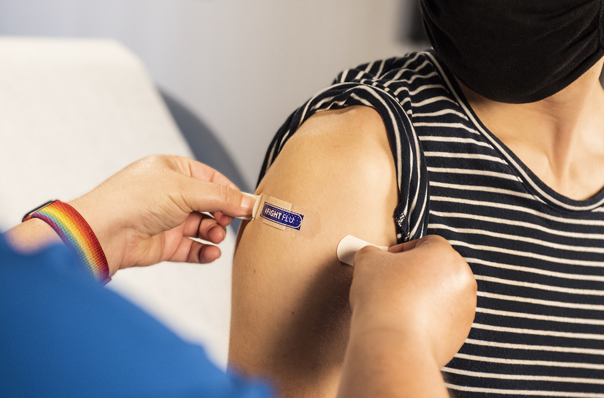 Person receiving vaccine shot in shoulder