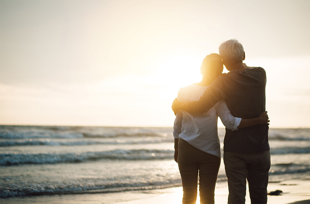 Senior couple walking on the beach