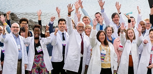group of physicians waving to camera