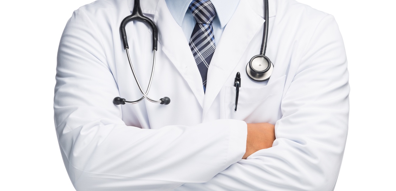 physician, wearing lab coat and stethoscope, with arms folded