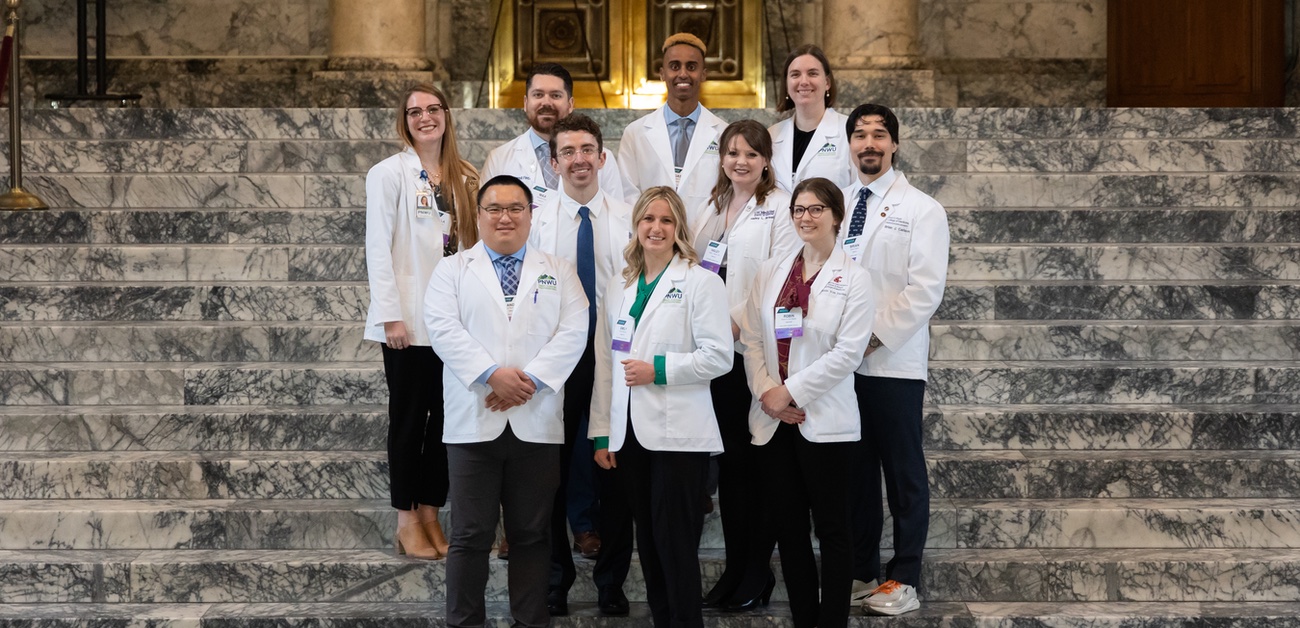 early career physicians posing on steps