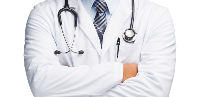 Physician with stethoscope standing with crossed arms