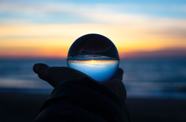 Glass sphere set against sunset photo