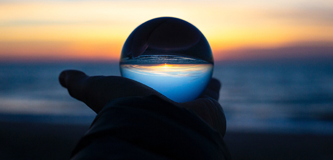 Crystal ball set against sunset