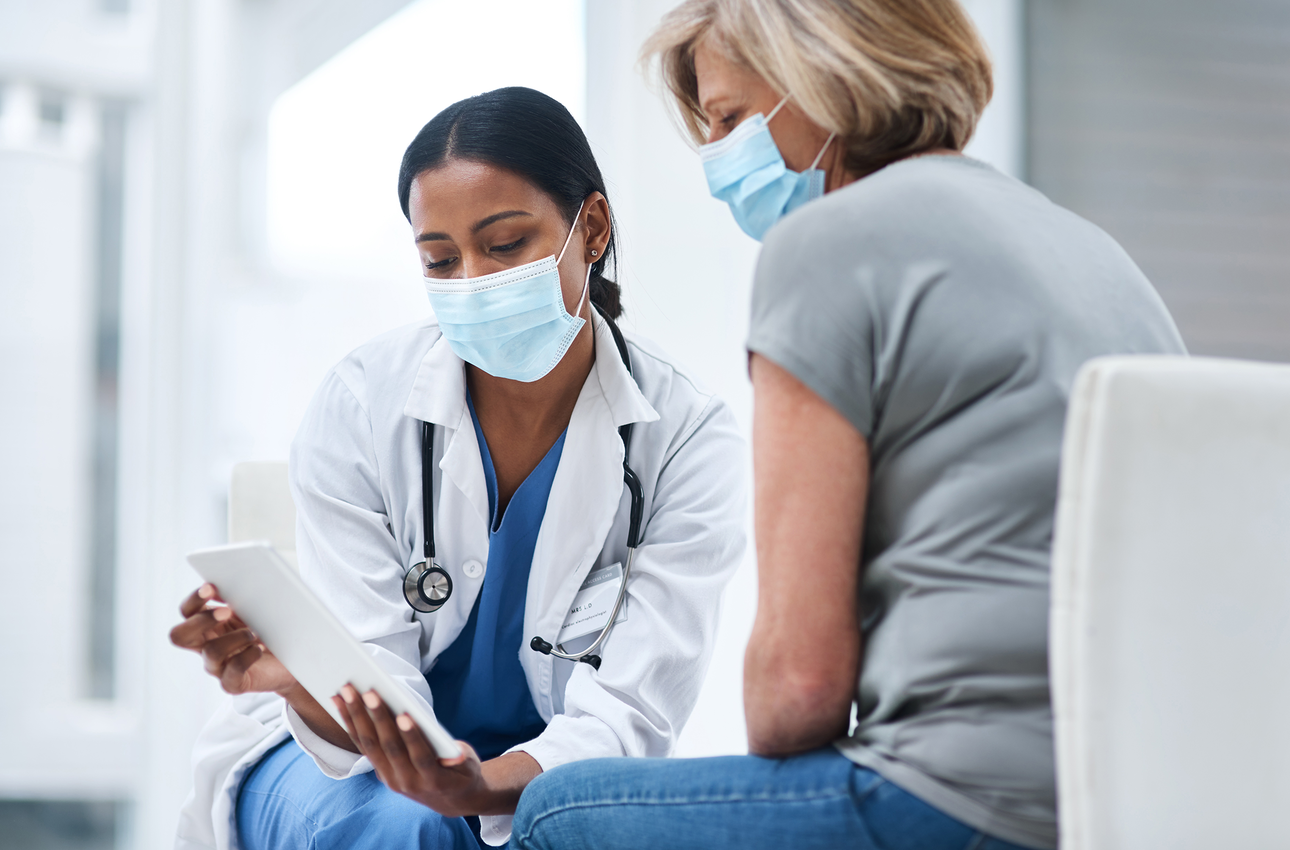 female doctor talking with female patient