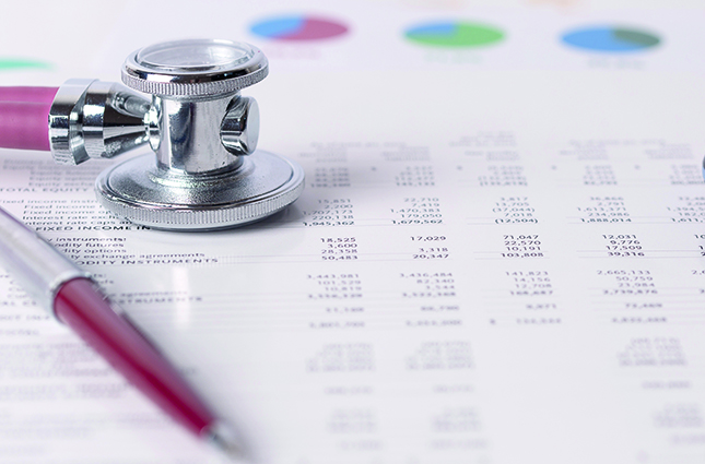 stethoscope and pen resting on a spreadsheet printout