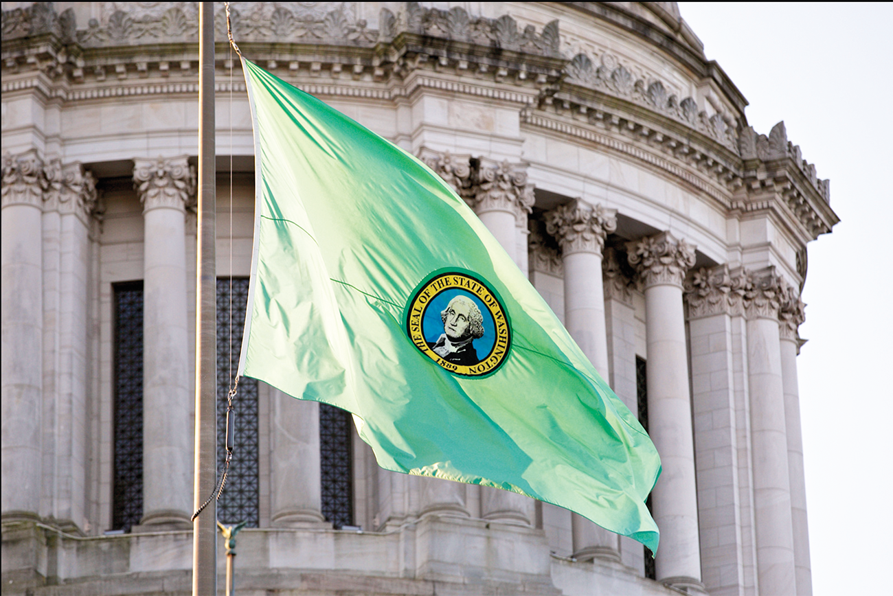 Washington state flag flying by capitol building