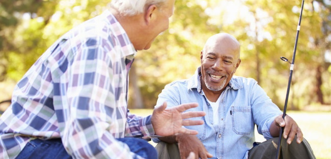 two older men talking while fishing