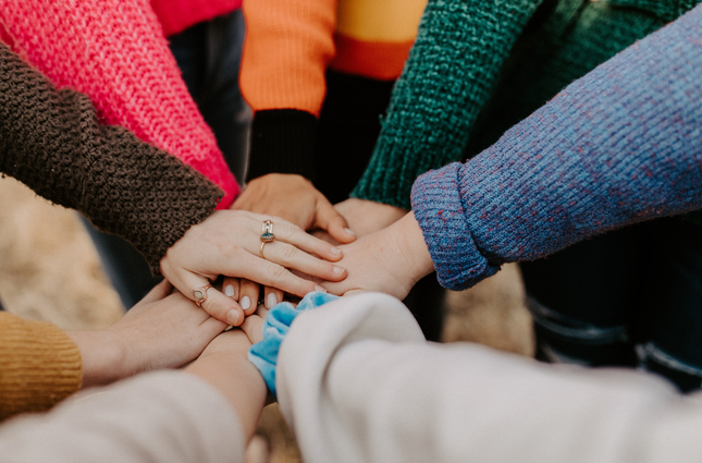 group of hands together in a huddle
