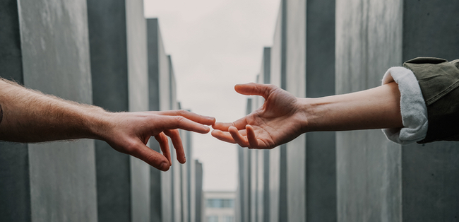 hands reaching towards each other