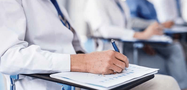 doctor writing at a desk